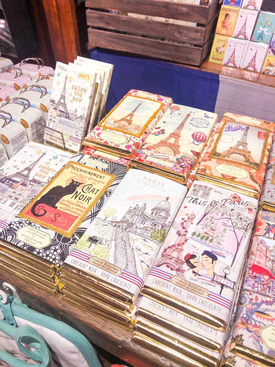 Chocolate bars in vintage packaging depicting the Eiffel Tower and Le Chat Noir at a souvenir shop