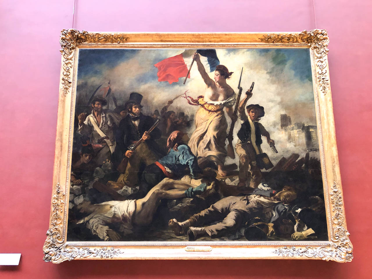 Liberty Leading the People by Eugène Delacroix hanging on the wall in the Louvre Museum in Paris