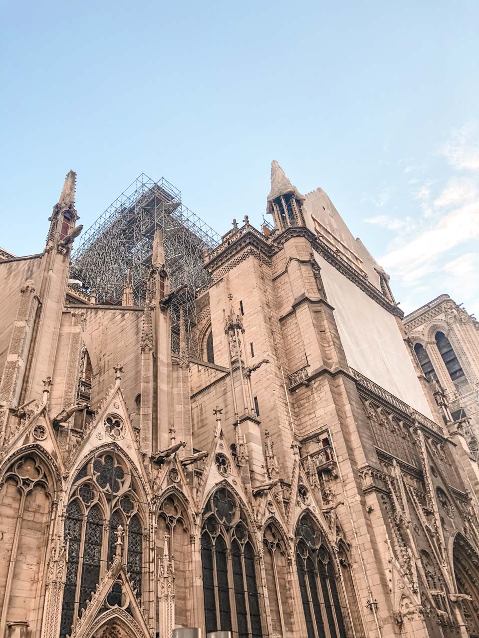 An upwards shot of Notre-Dame de Paris with scaffolding installed after the 2019 fire