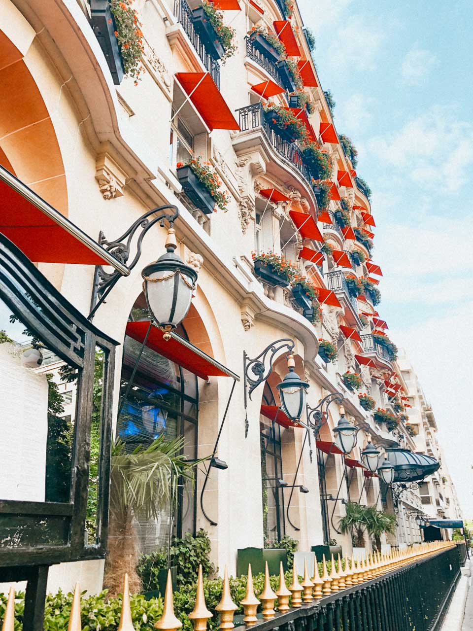 Red awnings and bright red geraniums at the Hôtel Plaza Athénée on Avenue Montaigne in Paris, France