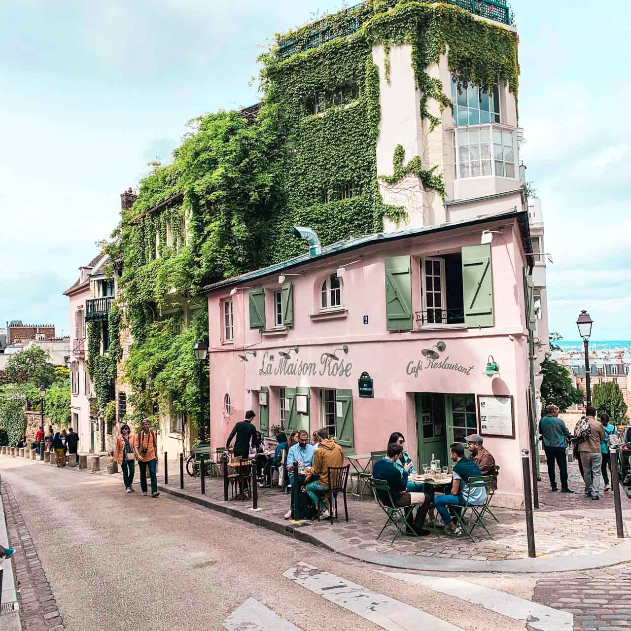People dining outside La Maison Rose in Montmartre, Paris