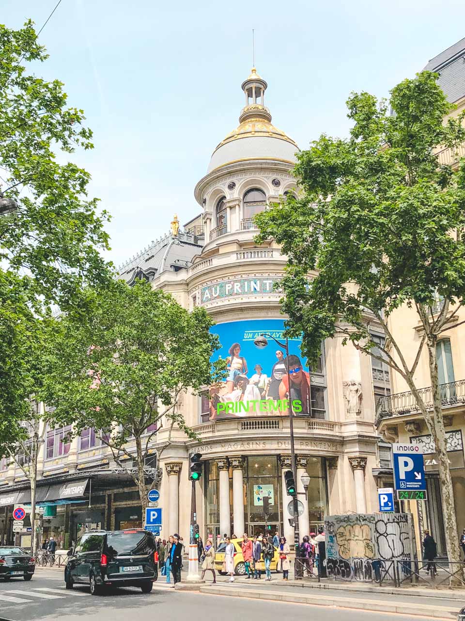 People walking outside the Printemps department store in Paris, France