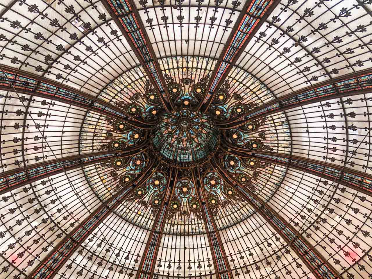 A close-up shot of the Art Nouveau stained-glass dome of Galeries Lafayette Paris Hausmann