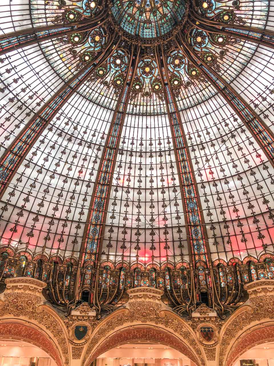 An Art Nouveau cupola topped by a stained-glass coloured dome at Galeries Lafayette Paris Hausmann