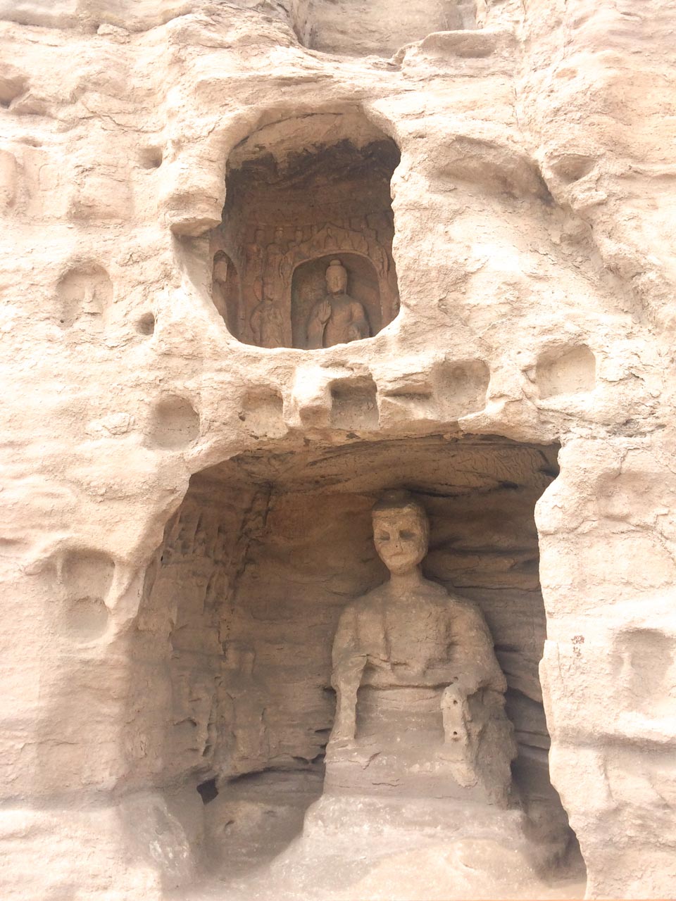 Statues carved into the cliffside at the Yungang Grottoes in Datong, Shanxi