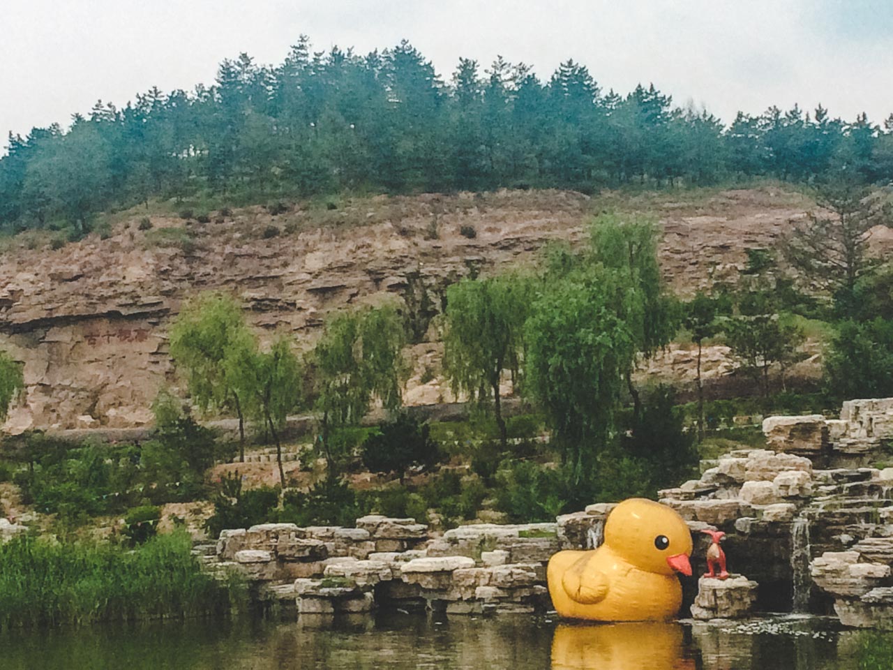 A rubber duck floating in the pond around the Lingyan Temple outside the Yungang Grottoes in Datong