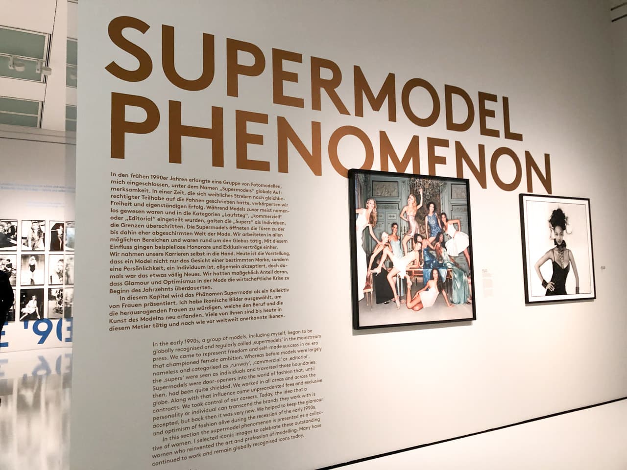 Wall with framed photos of supermodels and Supermodel Phenomenon written on it
