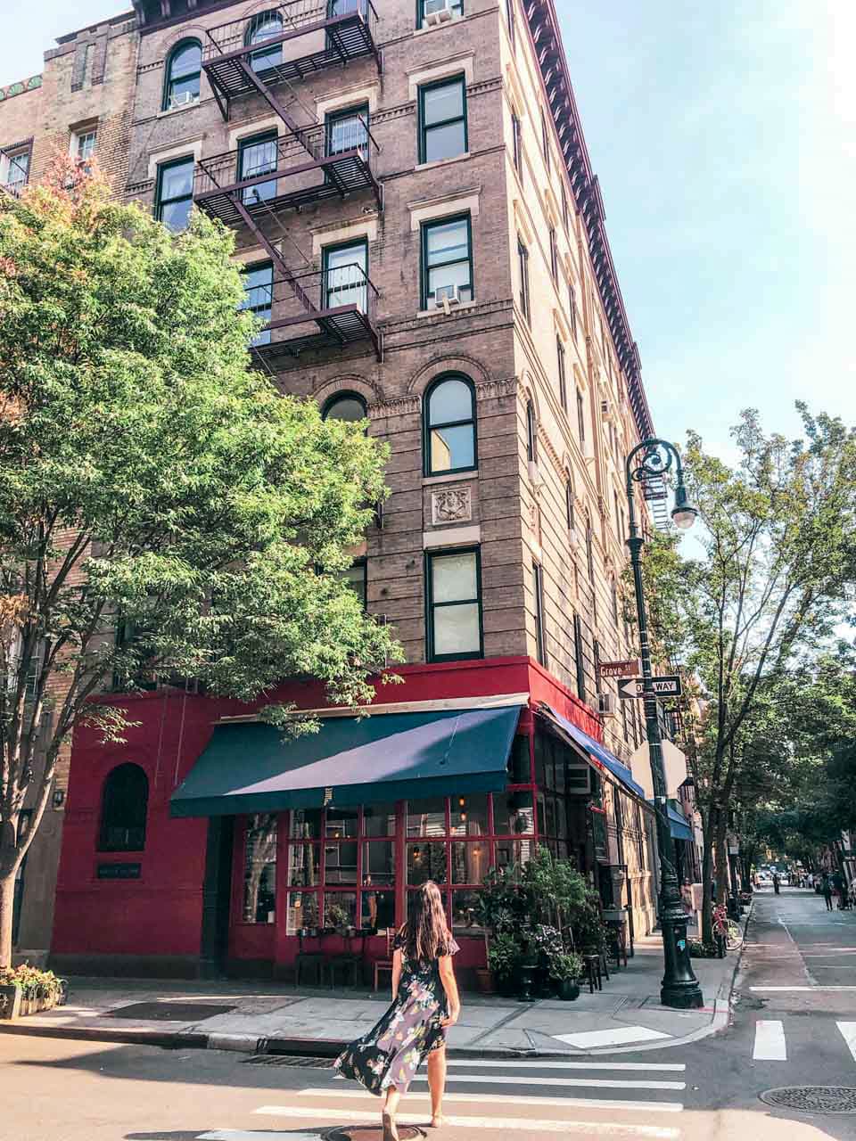 A girl walking across the street towards the Friends building in New York City