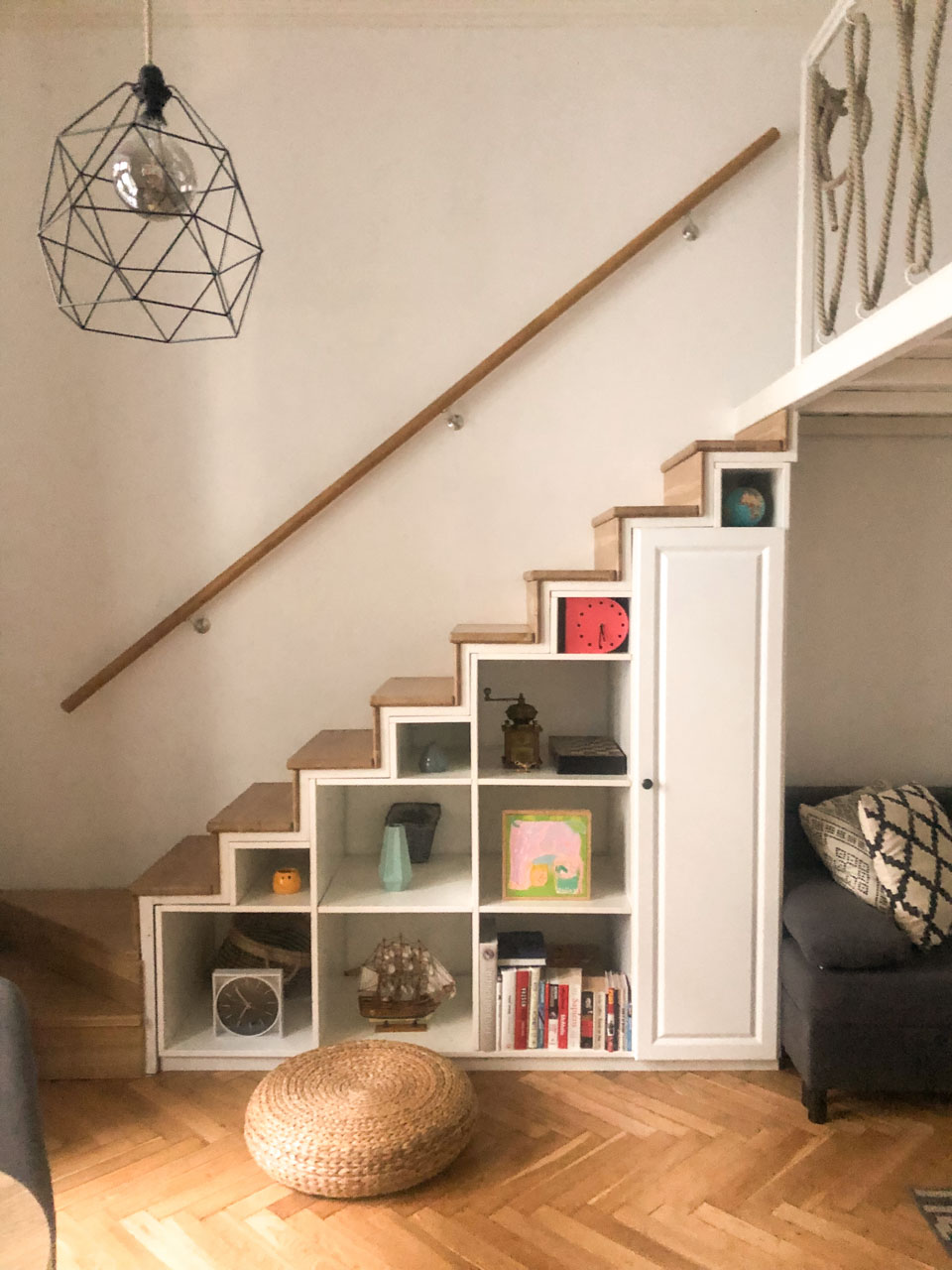 A shelving unit under the stairs