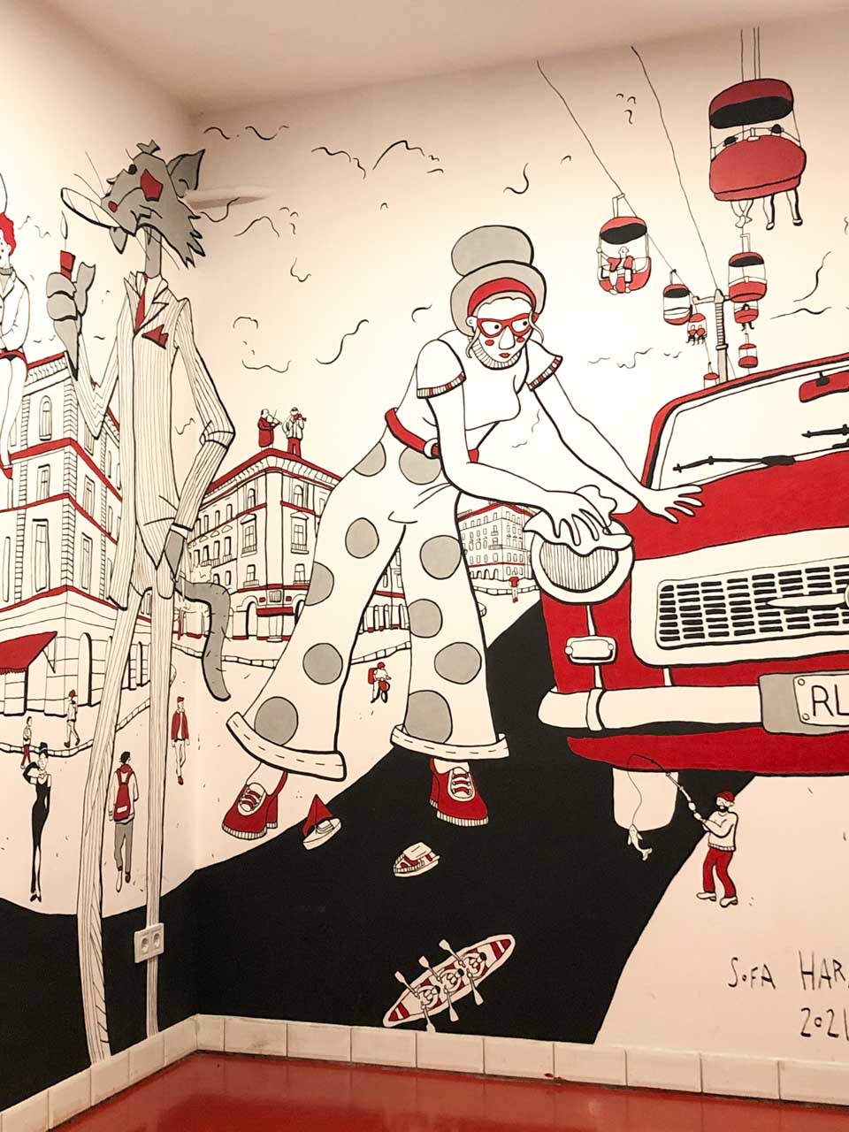 Red, black and white painting on the wall of Retró Lángos in Budapest