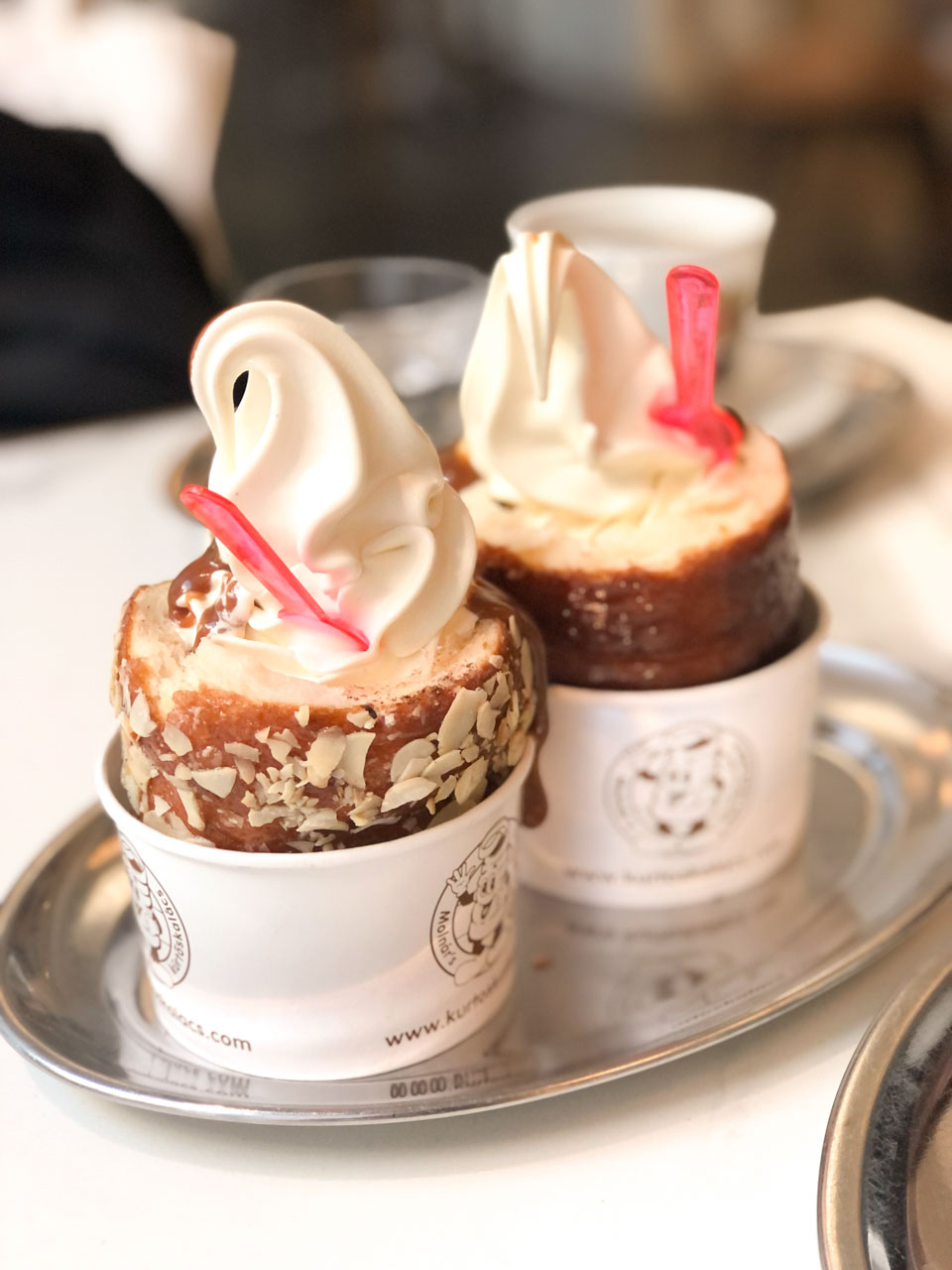 Two chimney cakes with ice cream on top