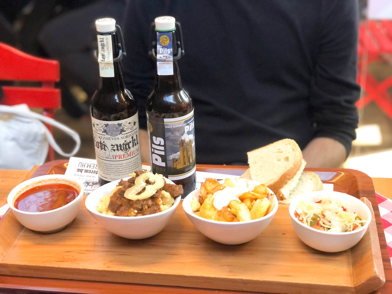 The tasting menu at the Fakanál Étterem restaurant consisting of 4 traditional Hungarian dishes next to 2 bottles of craft beer