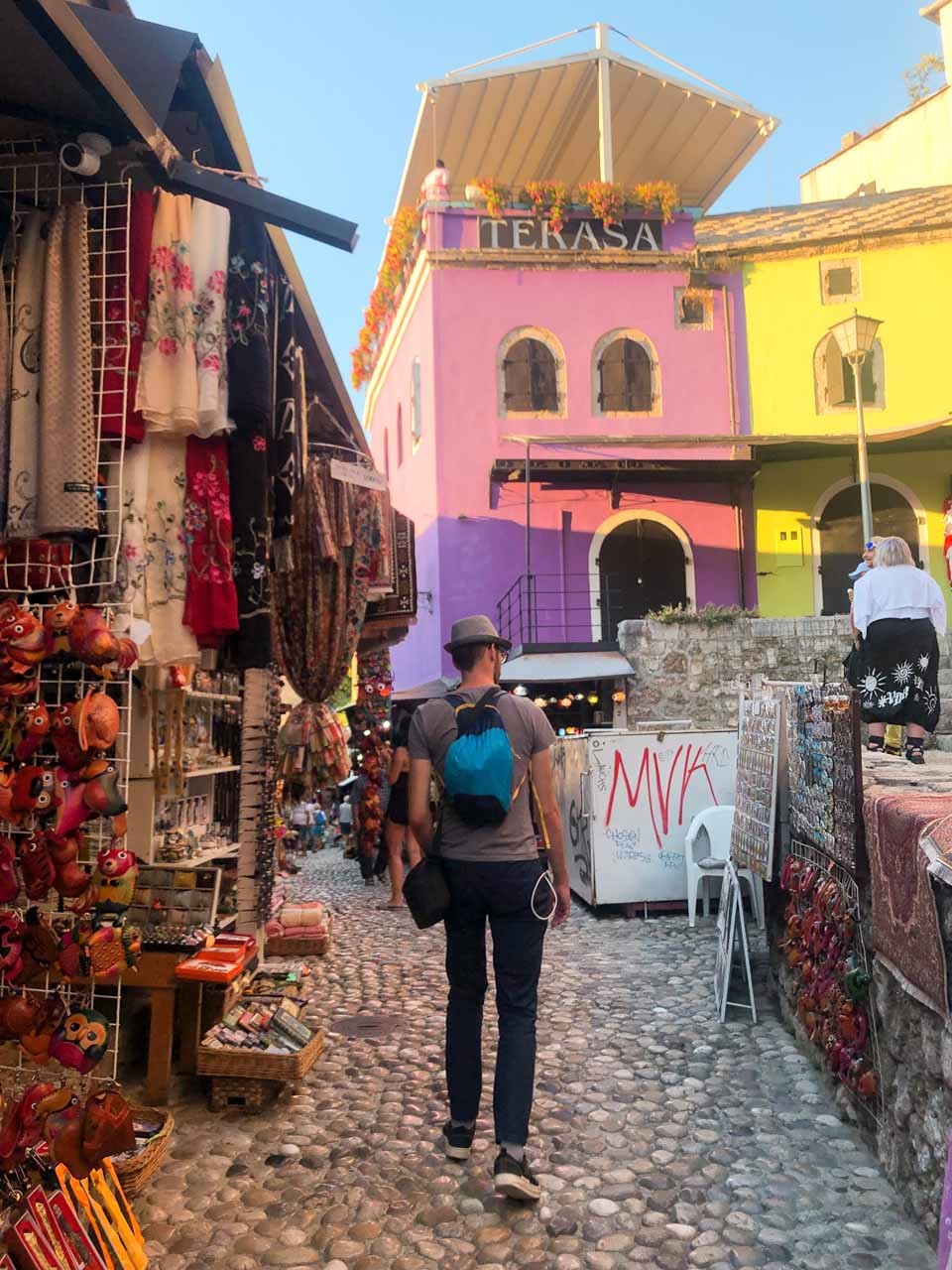 A man walking around the Old Bazaar in Mostar