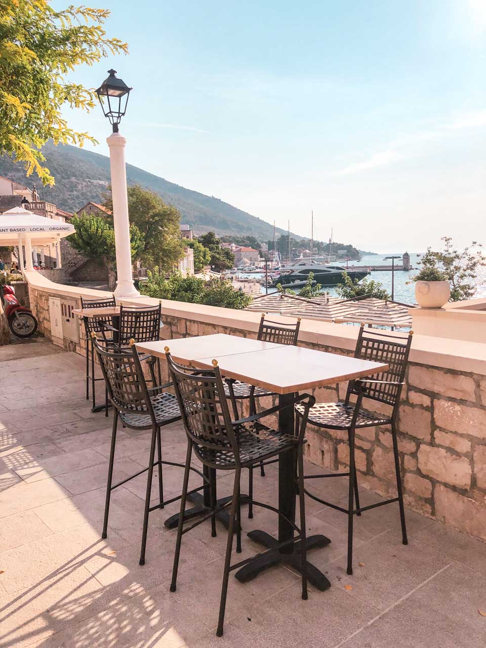 A table with chairs on an outdoor terrace in Bol, Croatia
