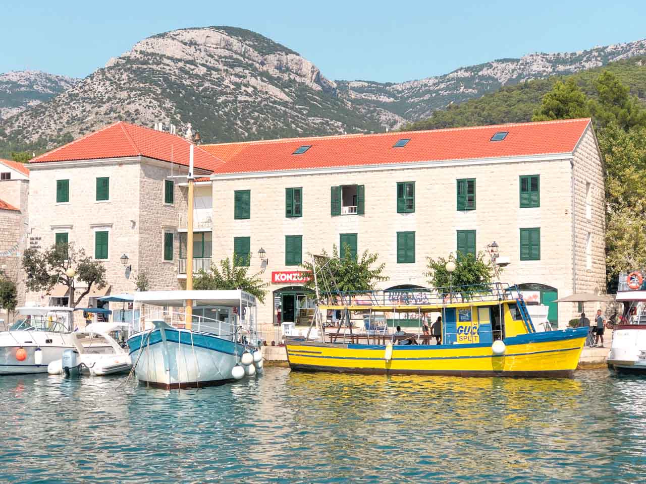 Boats docked at a harbour in Bol, Croatia