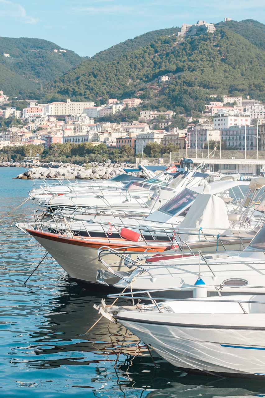 A row of boats docked in the port in Salerno, Italy