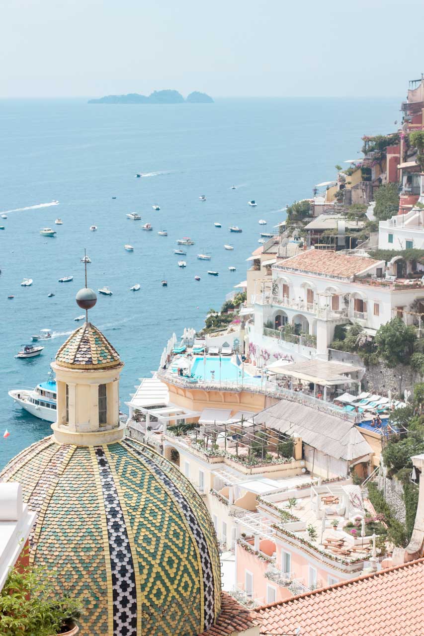The sea, hillside houses and the church dome seen from Le Sirenuse Hotel in Positano, Italy