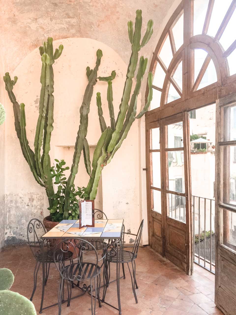 A cactus and a table at a café inside Giardino della Minerva