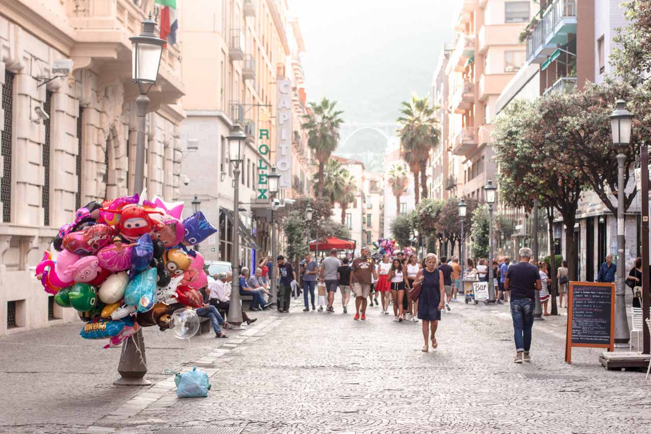 People walking on Corso Vittorio Emanuele street in Salerno, Italy