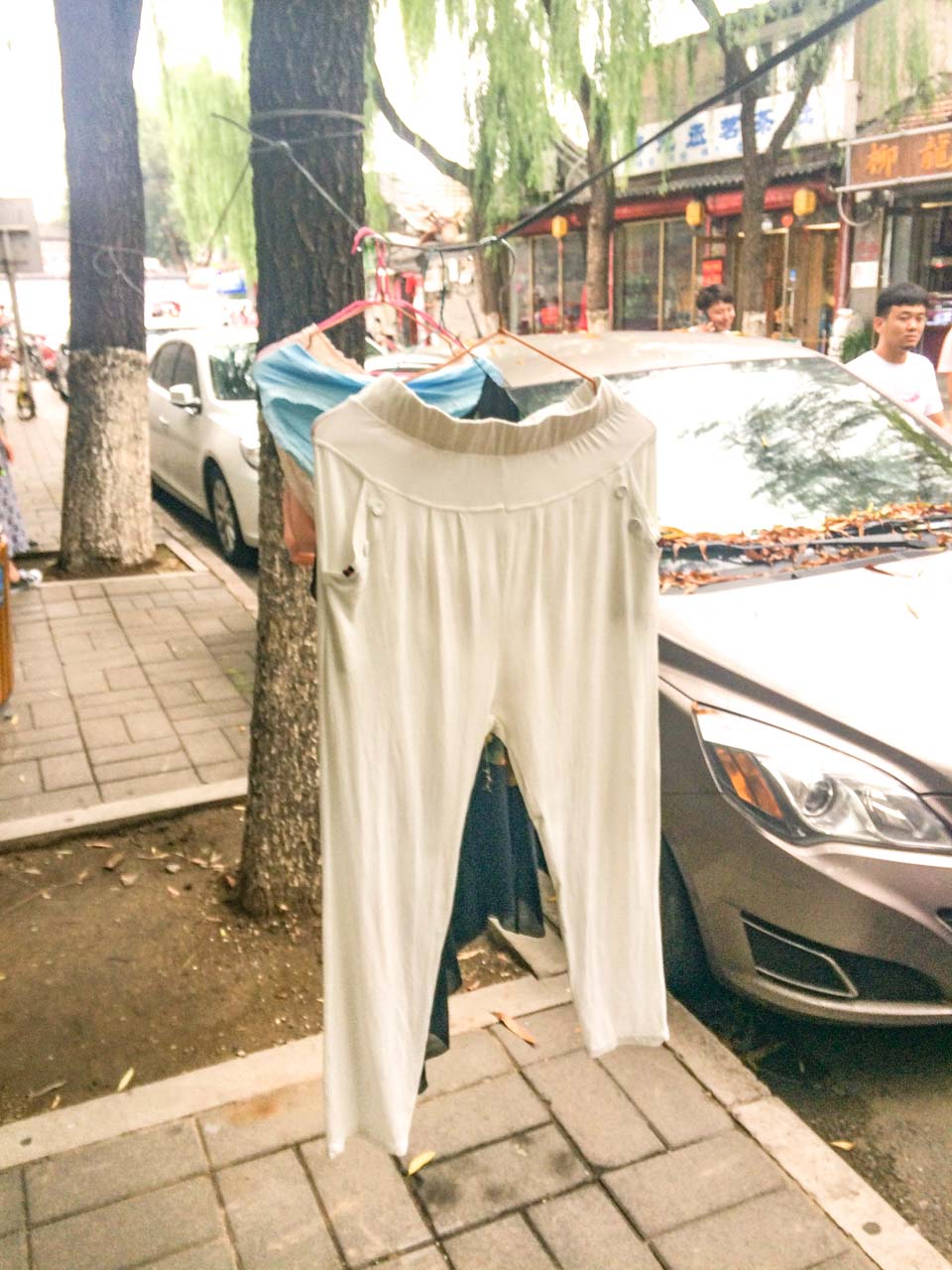 The washing hanging on an Ethernet cable in a street of Beijing, China