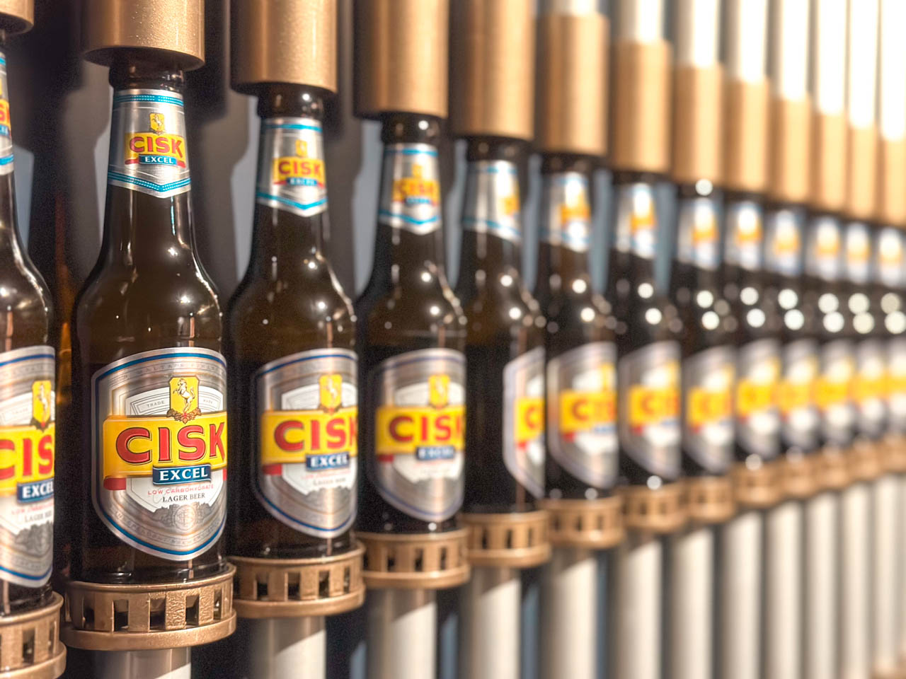 A row of Cisk beer bottles on display at the Farsons Brewery Experience in Malta