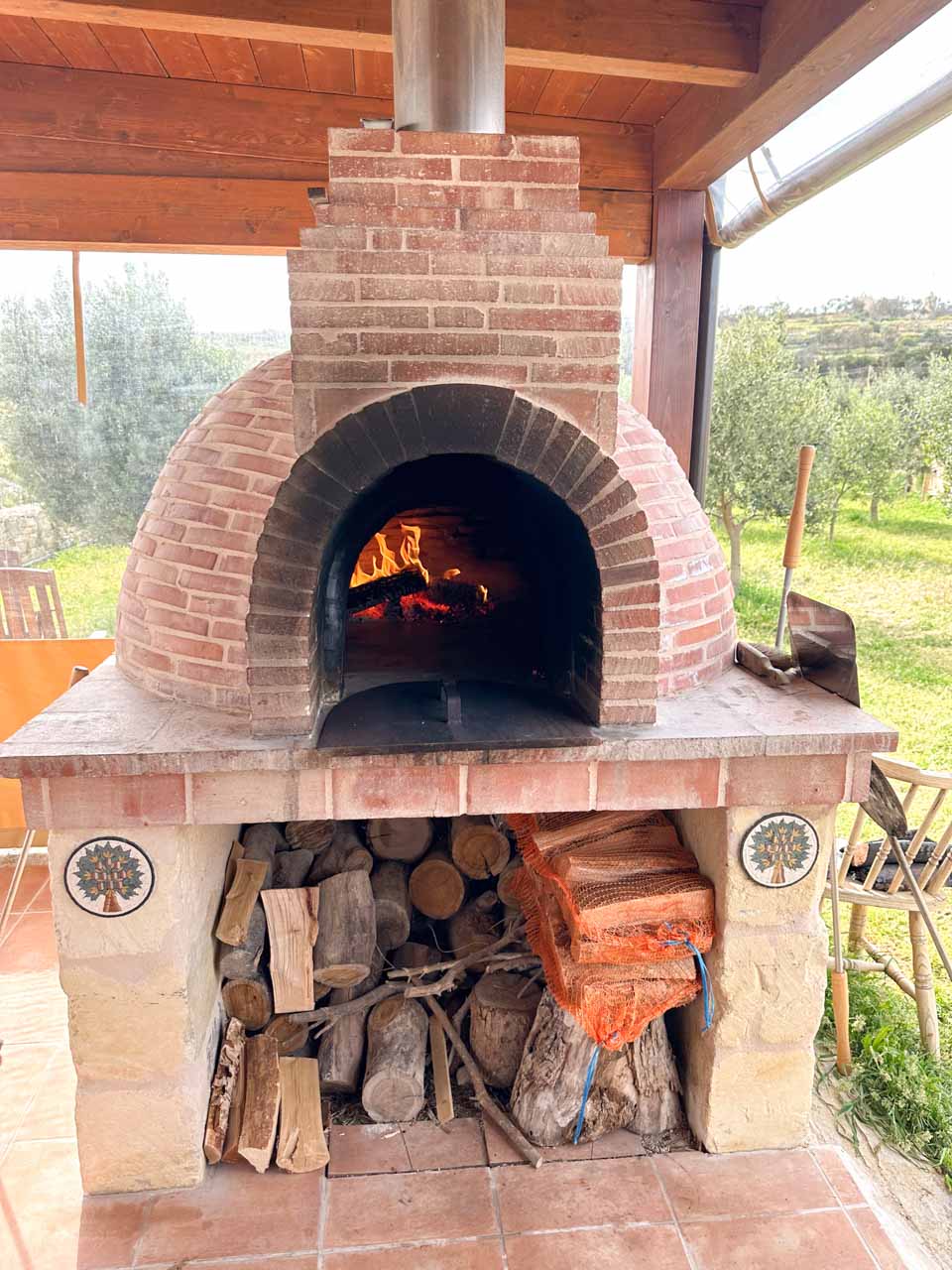 An outdoor wood-fired brick pizza oven