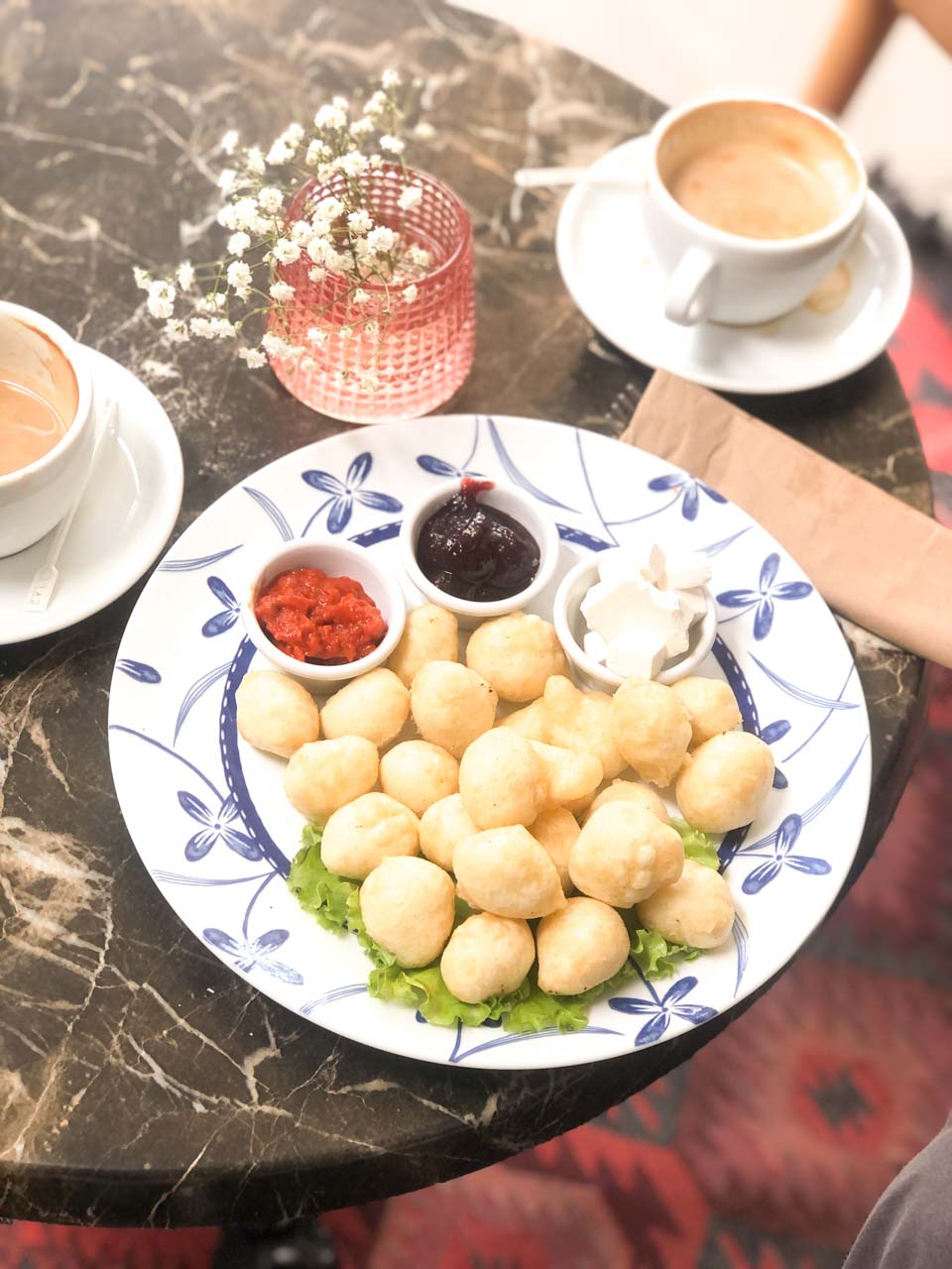 Albanian breakfast - petulla with white cheese, pepper spread, and jam - at Dit’ e Nat’ in Pristina, Kosovo