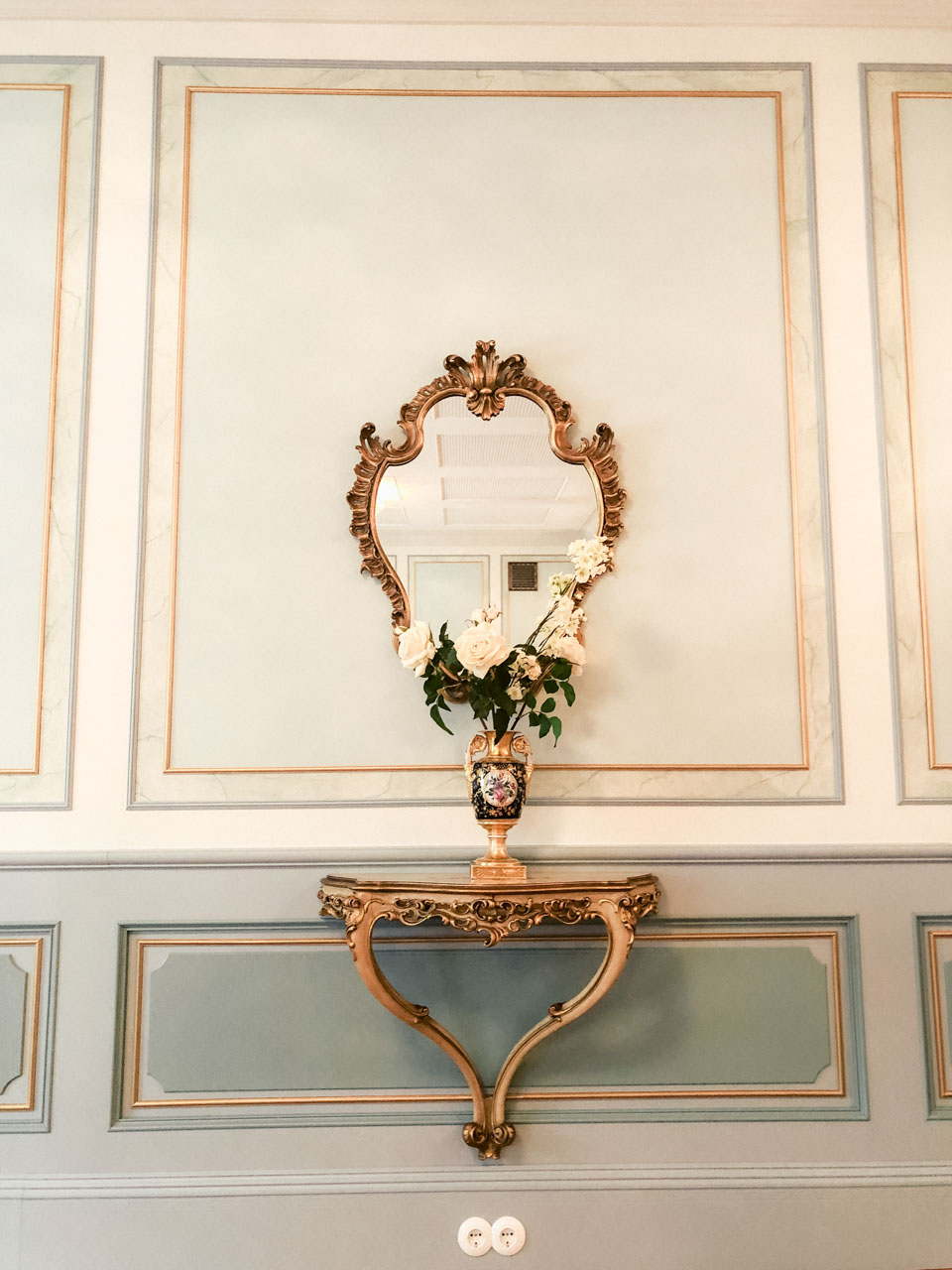 A mirror in a golden frame on the wall of the House of the Blackheads