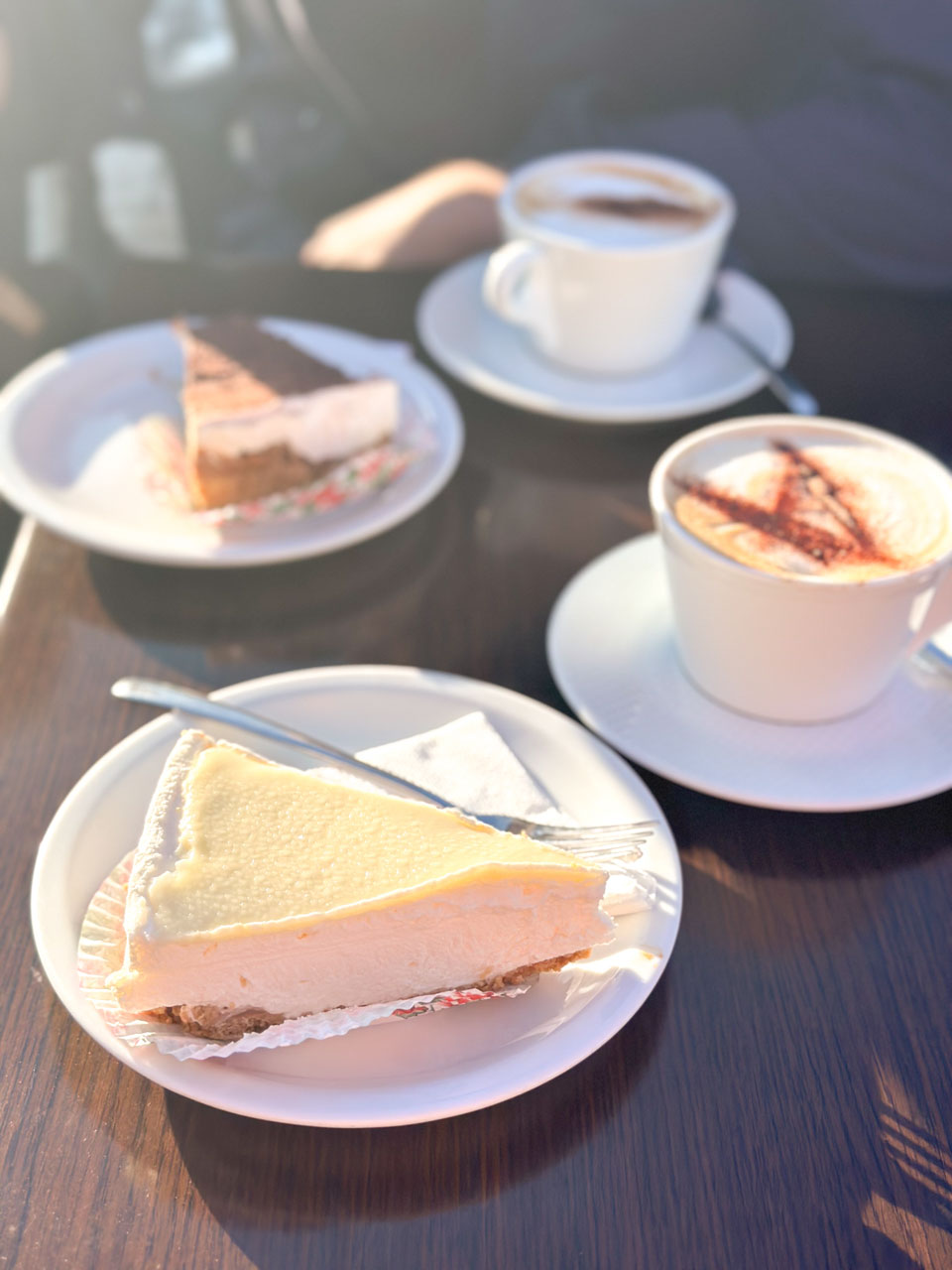 Two slices of cake and two cups of coffee on a table at Fontanella Tea Garden