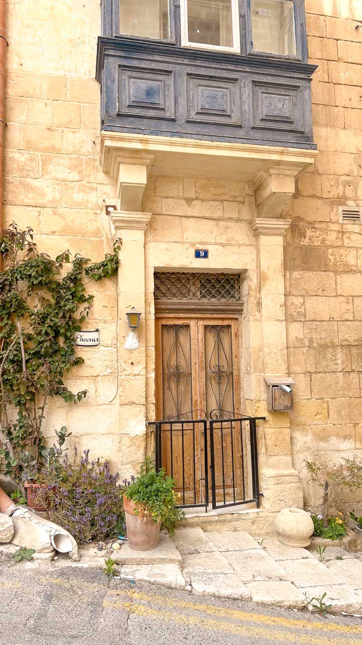 A Maltese house with a traditional wooden balcony in Valletta, Malta