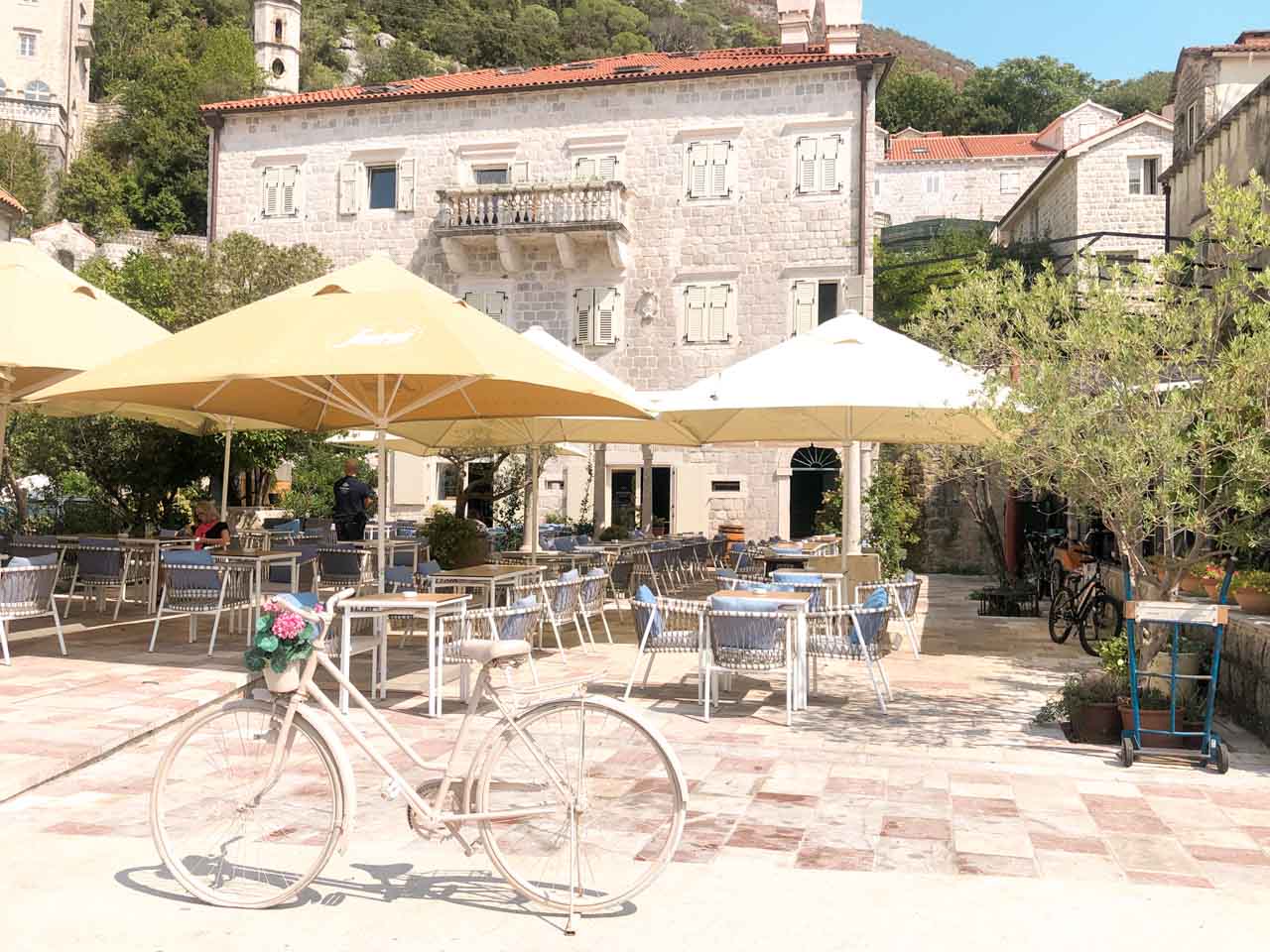 Bike parked on the outdoor terrace of a restaurant in Perast, Montenegro