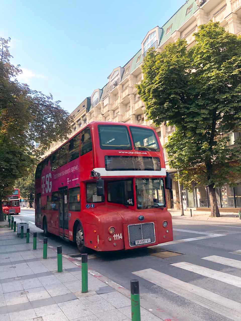 Red double-decker bus in the streets of Skopje, North Macedonia