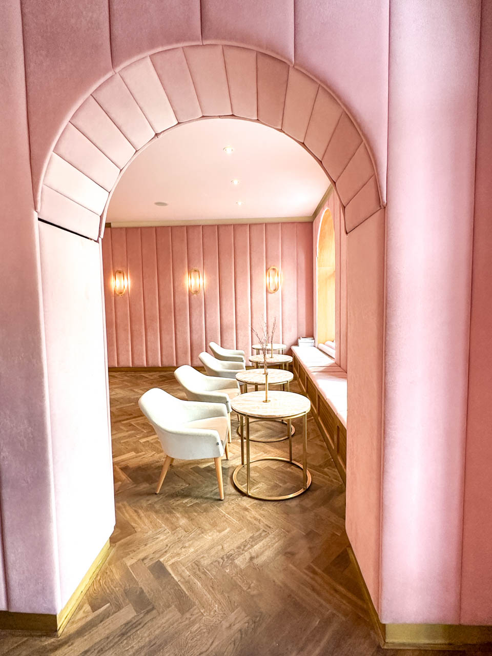 Arched doorway and walls upholstered in pink velvet at NANAN Patisserie in Wrocław, Poland