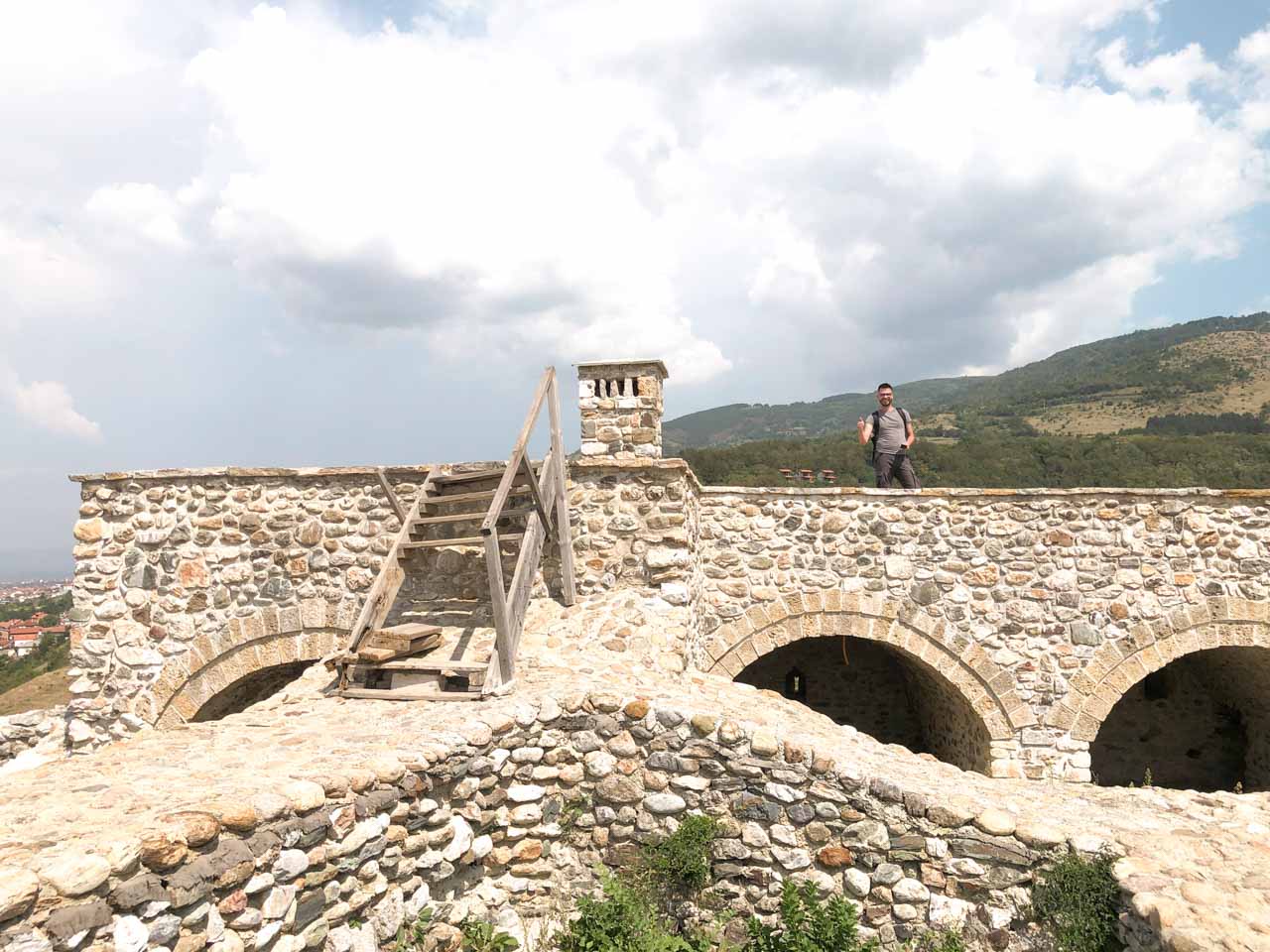 Man standing among the ruins of the Prizren Fortress