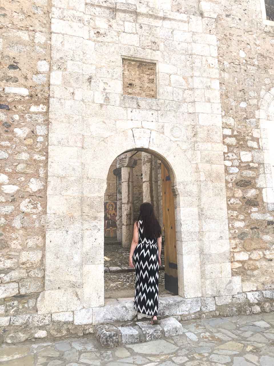 Woman in a black and white maxi dress entering the Church of the Holy Saviour in Prizren, Kosovo