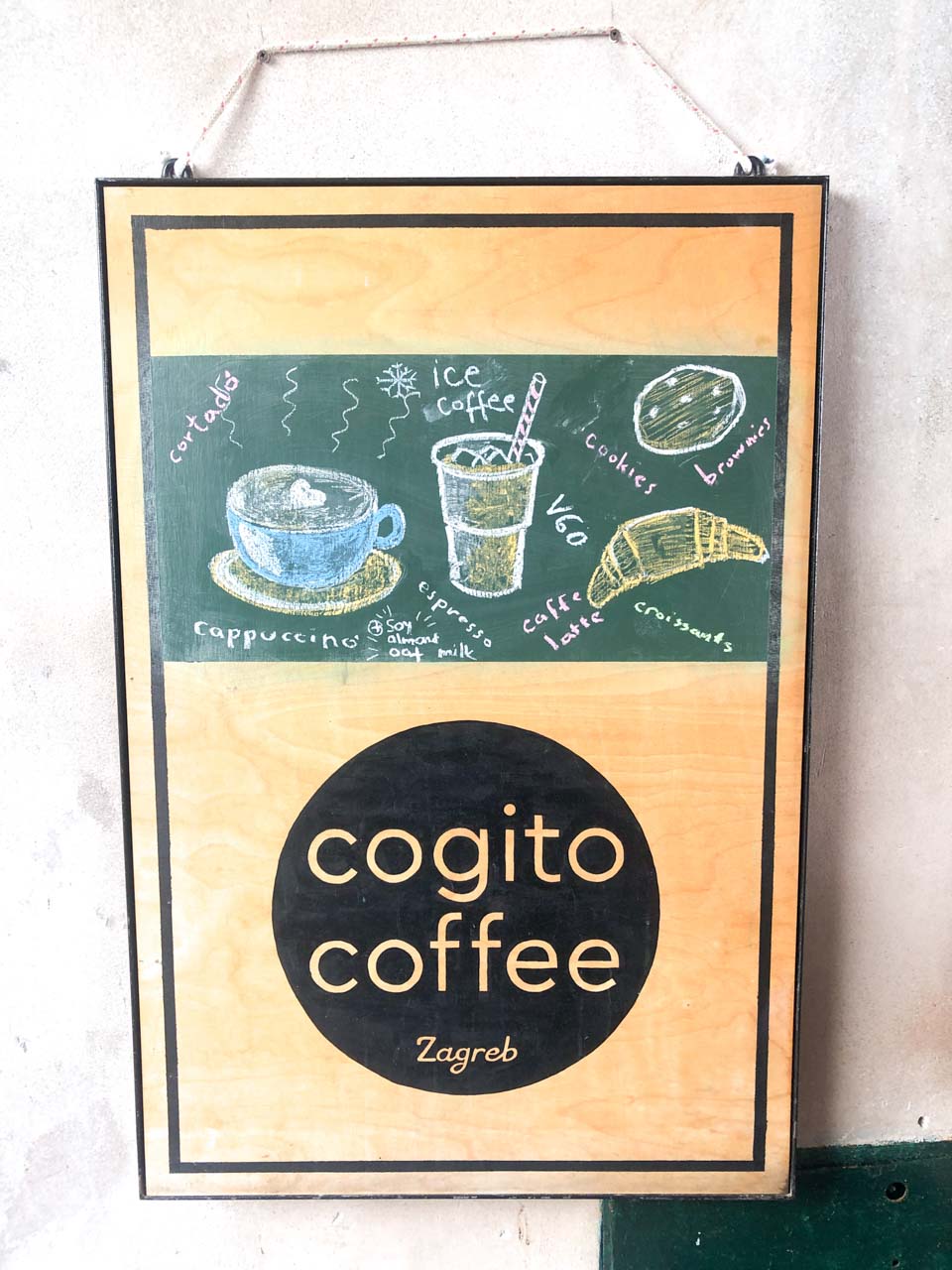 Sign hanging by the entrance to Cogito Coffee in Dubrovnik Old Town