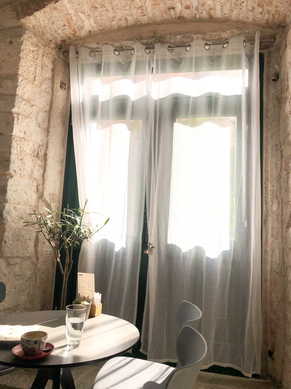 White curtain covering the door inside D16 Coffee in Split Old Town