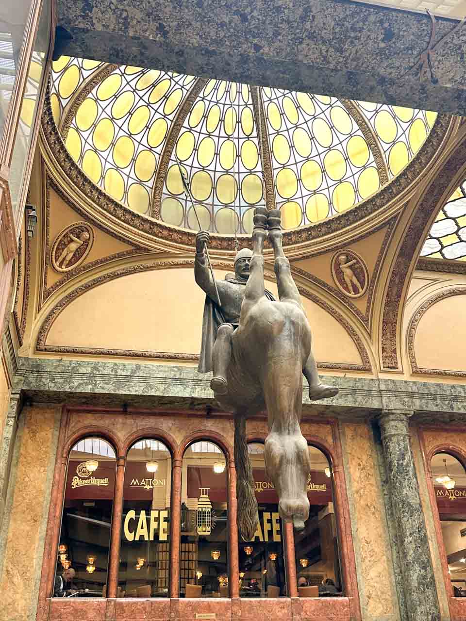 Statue of St. Wenceslas riding an upside-down dead horse inside the Lucerna Passage in Prague