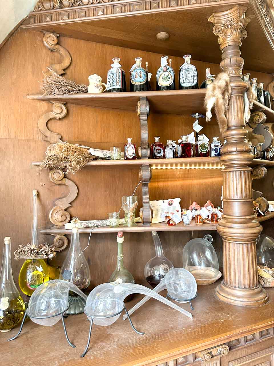 Small bottles and potion brewing equipment on display at Speculum Alchemiae in Prague