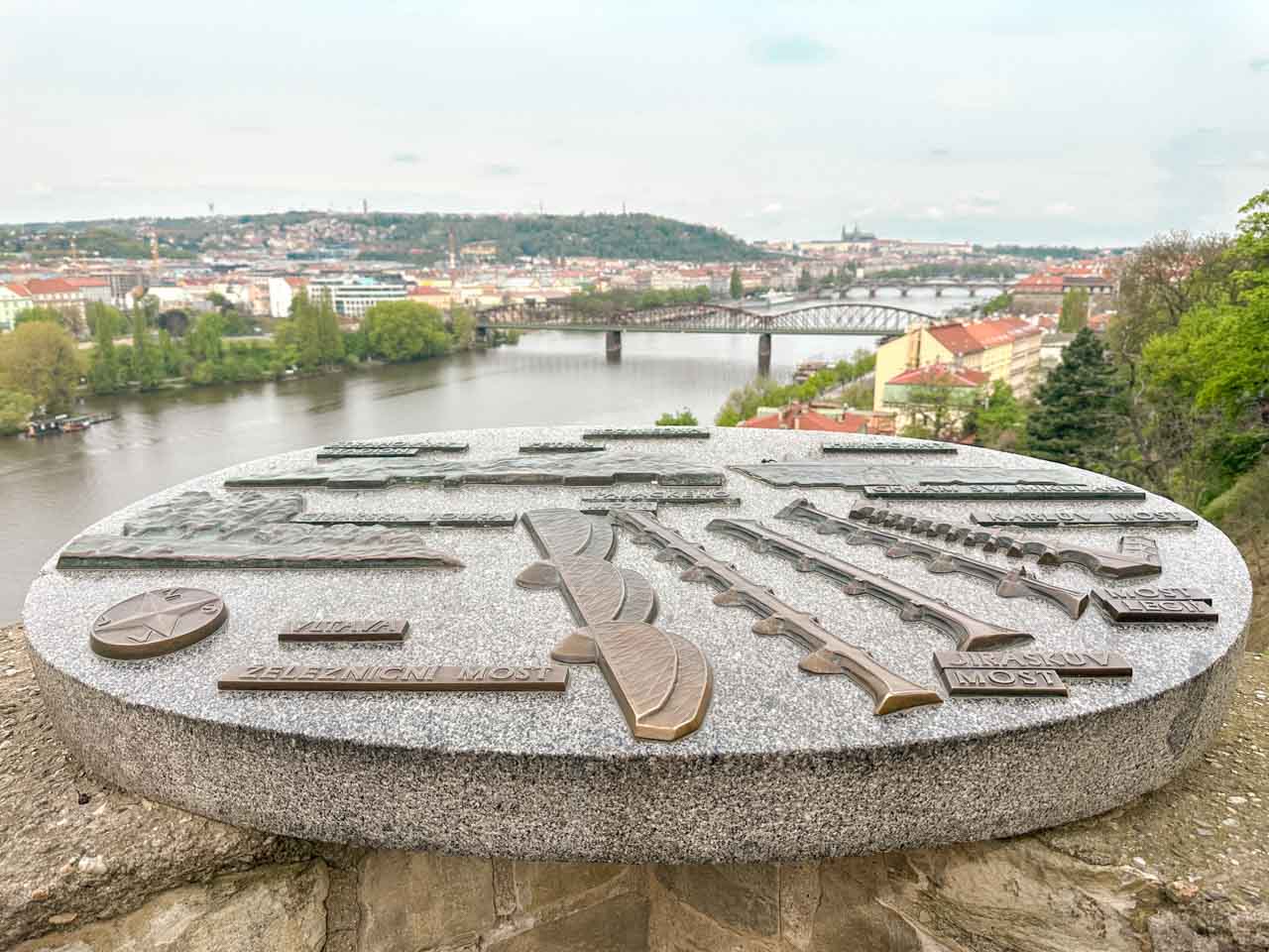 Iron map of Prague in Vyšehrad with Vltava River and Prague Castle seen in the background