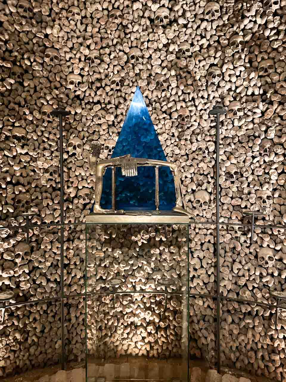 Human bones inside the Brno Ossuary surrounding a blue triangular structure