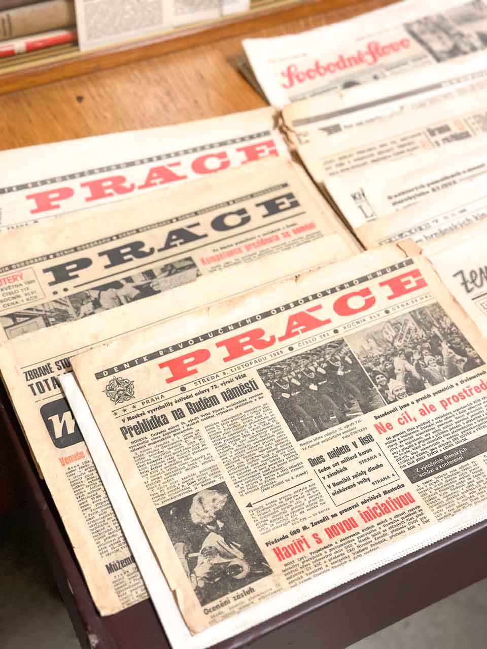 Vintage Czech newspapers on a wooden table
