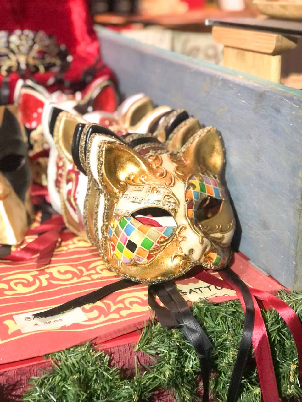 Elegant Venetian masks with intricate gold designs on display at the Sister Cities Market in Nuremberg