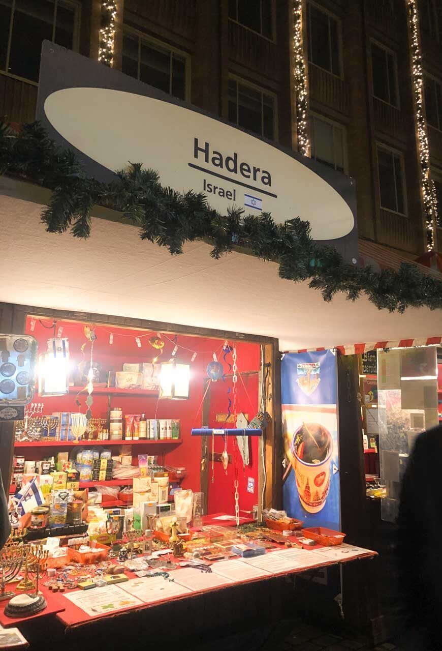 A booth at the Sister Cities Market in Nuremberg representing Hadera, Israel, decorated with cultural items and festive lights
