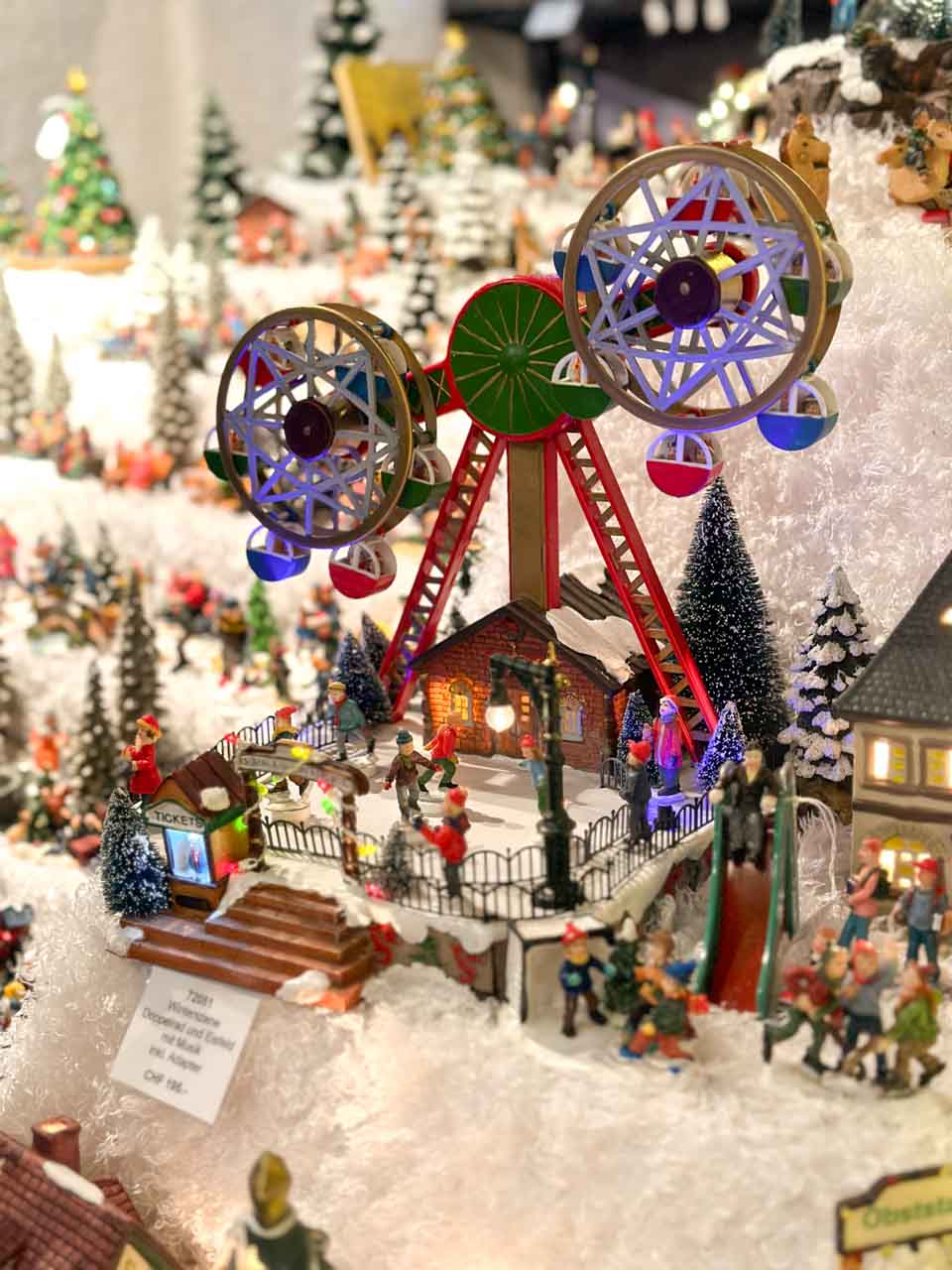 A small, festive fairground model with a spinning Ferris wheel at the Basel Christmas market on Barfüsserplatz