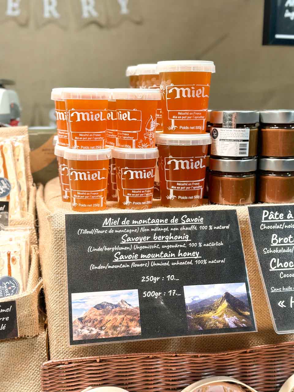 Jars of Savoie honey on display with price tags at a Christmas market stall on Barfüsserplatz in Basel