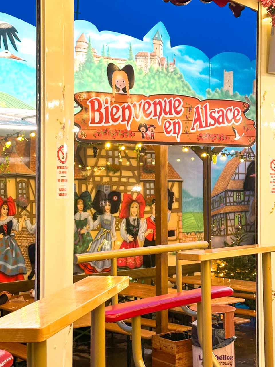 A sign that reads 'Bienvenue en Alsace' on Place Rapp in Colmar