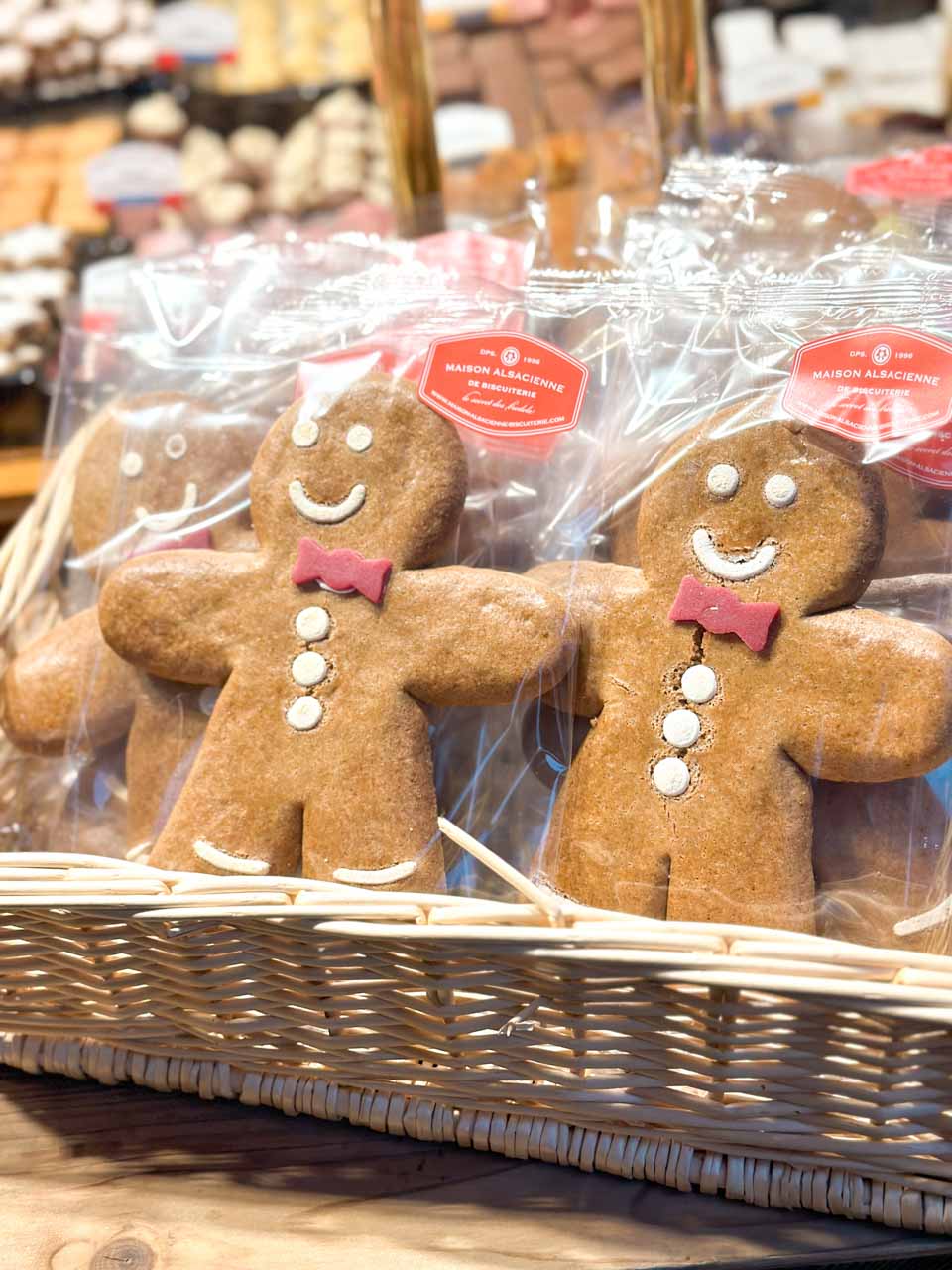 A selection of smiling gingerbread men, wrapped and ready for sale at the Colmar Christmas Market