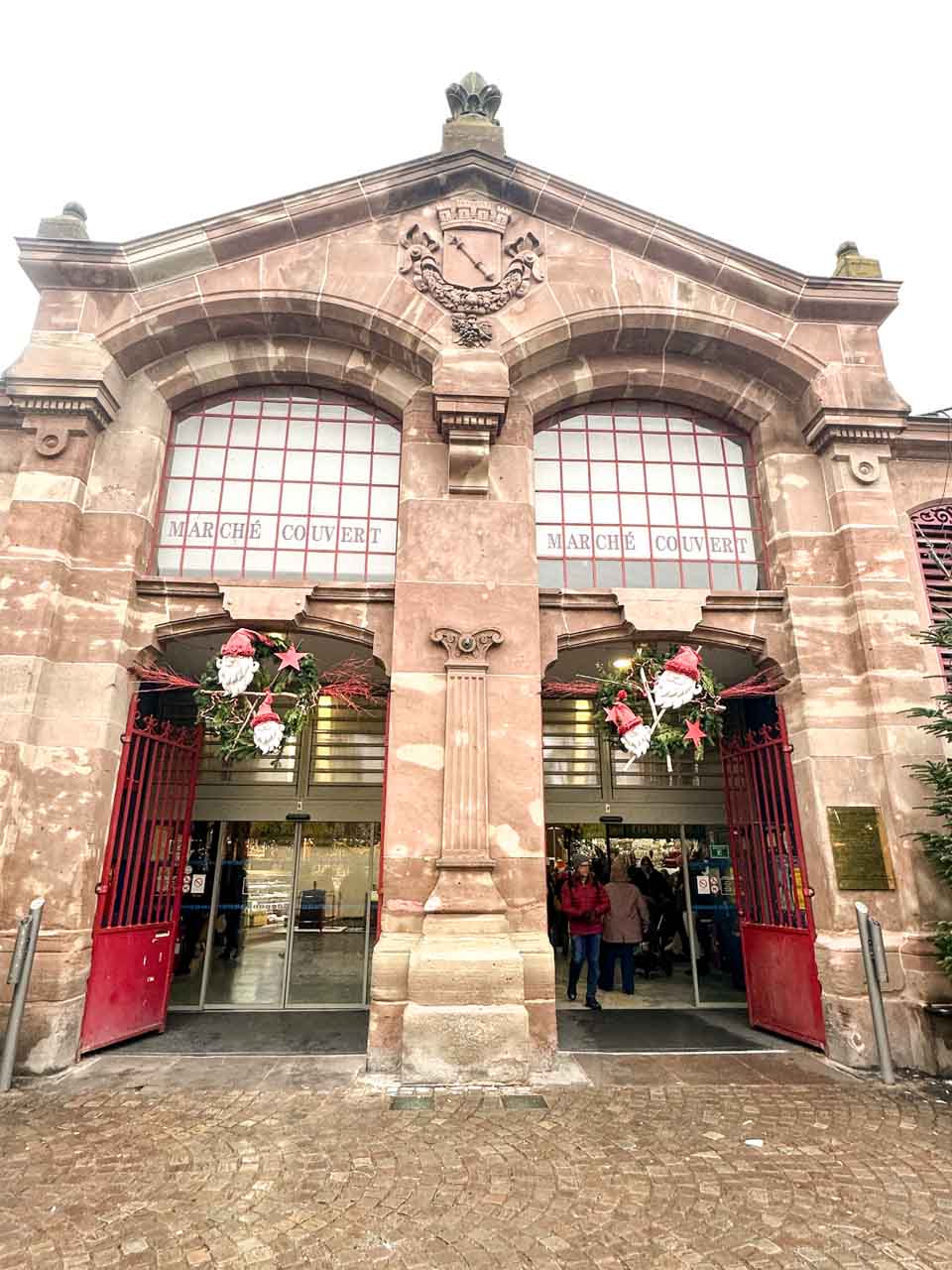 The front of Colmar's covered market, Marché Couvert, decorated with Christmas wreaths