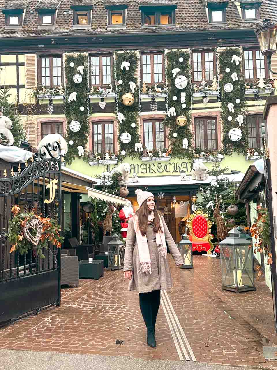 A woman in a winter coat standing in front of Hotel Le Mar&eacute;chal in Colmar, Alsace